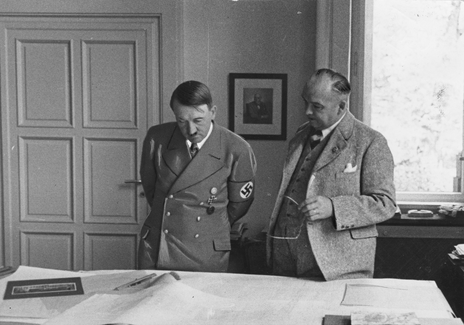 Adolf Hitler during a visit to the atelier of architect Woldemar Brinkmann, he is shown the plans for Munich's opera and Berlin's Reichstag